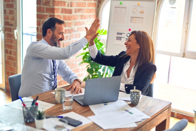 A man and a woman high-fiving