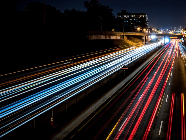 time lapse of car lights on a highway